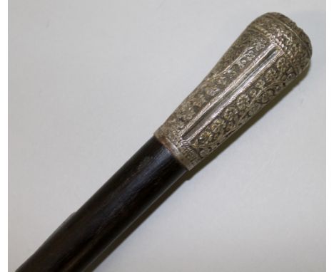 AN INDIAN EBONY WALKING STICK WITH SILVER HANDLE.  35ins long.