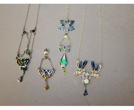 FOUR SILVER AND ENAMEL PENDANTS and three chains.