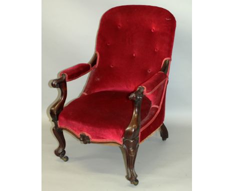 A VICTORIAN MAHOGANY OPEN ARMCHAIR with button upholstered back, carved show wood frame on cabriole legs.