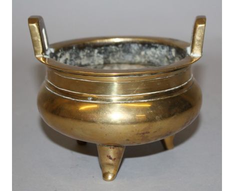 A CHINESE POLISHED BRONZE TRIPOD CENSER, weighing 840gm, the rim with double upright lug handles, the base with a Xuande seal