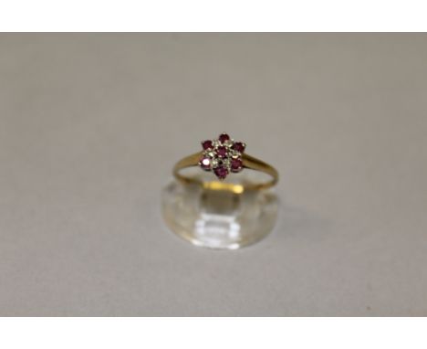 A SMALL RUBY AND DIAMOND CLUSTER RING.
