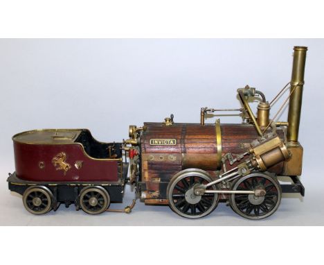A WOODEN AND BRASS MODEL OF AN EARLY STEAM ENGINE with nameplate INVICTA, 11ins long, complete with TENDER, 7.5ins long.