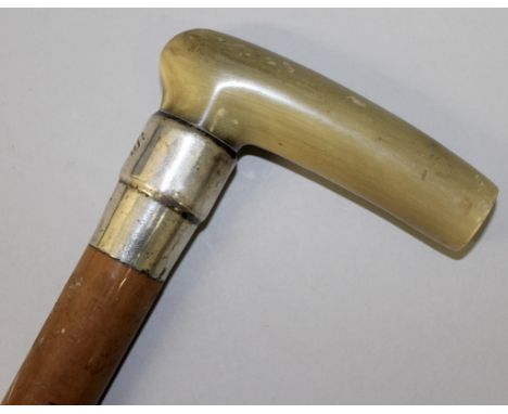 A HORN HANDLED STICK with silver band dated 1897.  Initials J. S. 36ins long.