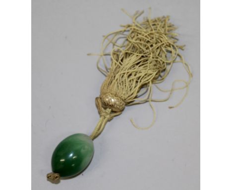 A GREEN JADE PENDANT.