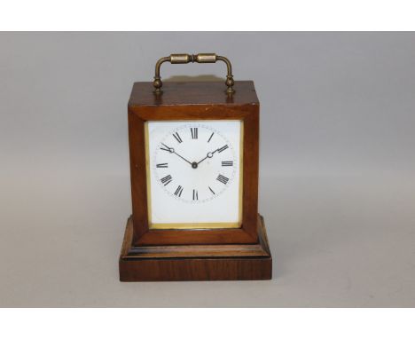 A 19TH CENTURY FRENCH TIMEPIECE CLOCK in a rosewood case with brass carrying handle.6ins high.