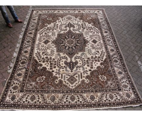 A Hamadan carpet, beige ground with stylized floral decoration in various tones of brown. 11ft 0ins x 8ft 3ins.