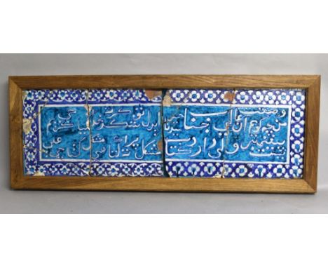 A LARGE WOOD FRAMED ISLAMIC RECTANGULAR GLAZED CERAMIC TILE, possibly early, its centre with a panel of script reserved in wh