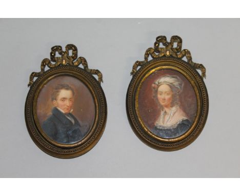 A SMALL PAIR OF VICTORIAN IRISH PORTRAIT MINIATURES of a gentleman in a black coat and a woman with lace trimmed dress, 2.25i