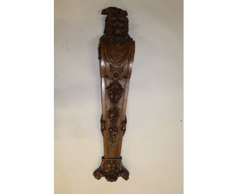A GOOD CARVED OAK BRACKET, 3ft 8ins long, carved with a Dog of Foe, acanthus etc.