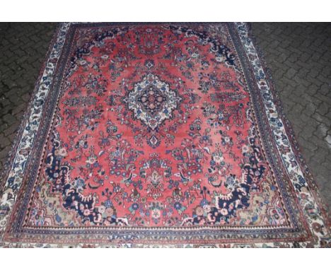 A good Hamadan pink ground carpet, red ground with floral decoration. 12ft 9ins x 9ft 6ins.