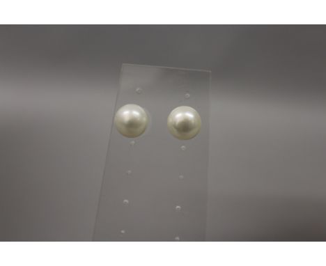 A pair of freshwater pearl button earrings, each fitted with 9ct gold fittings.