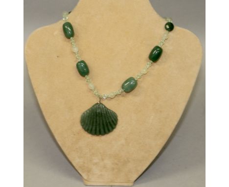 A GREEN JADE PENDANT AND CHAIN.