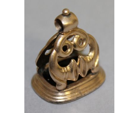 A ROSE GOLD MOUNTED FOB SEAL, the rounded dark brown intaglio incised with a male portrait profile, with scroll surmount.  2.