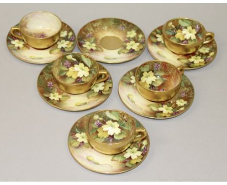 A SET OF FIVE ROYAL WORCESTER CUPS AND SIX SAUCERS painted with primroses by TWIN.