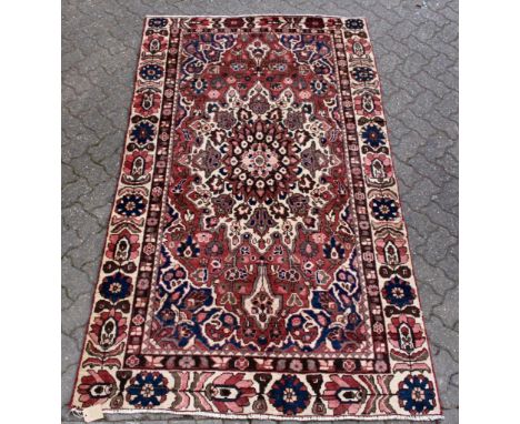 A Hamadan carpet, rust ground with all over floral motifs. 8ft 0ins x 4ft 7ins.