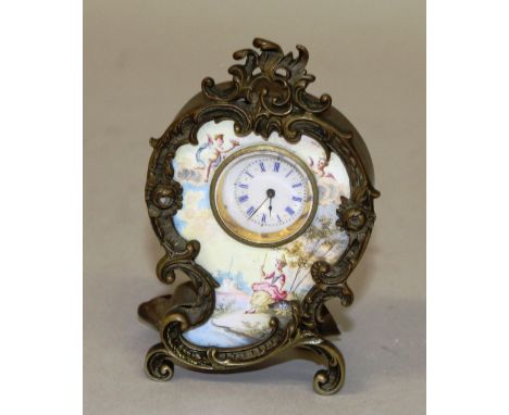 A SMALL FRENCH VIENNA ENAMEL ROCOCO DESIGN CLOCK with circular dial with blue and white Roman numerals, the front with a Vien