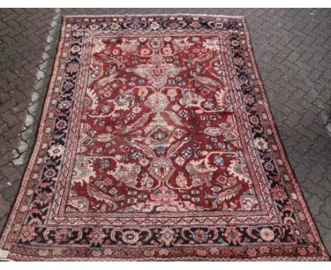 A Hamadan carpet, claret ground with stylized floral decoration. 10ft 5ins x 7ft 6ins.