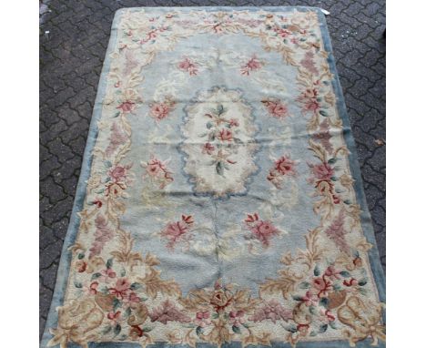 An Indian carpet, pale green ground with red floral decoration. 9ft 4ins x 5ft 10ins.