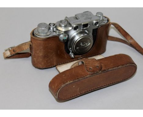 A LEICA CAMERA, NO. 415550, in a leather case.