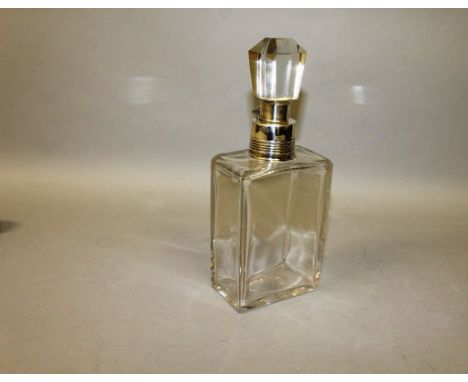 A SILVER TOP LOCKING DECANTER.