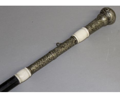 AN ISLAMIC EBONY WALKING CANE SWORD STICK with silver and ivory handle.