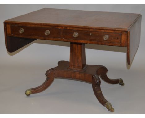 A REGENCY ROSEWOOD SOFA TABLE with crossbanded top and folding flap, two frieze drawers with brass handles, centre support, p