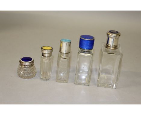 FIVE VARIOUS SCENT BOTTLES with various colour enamel tops.