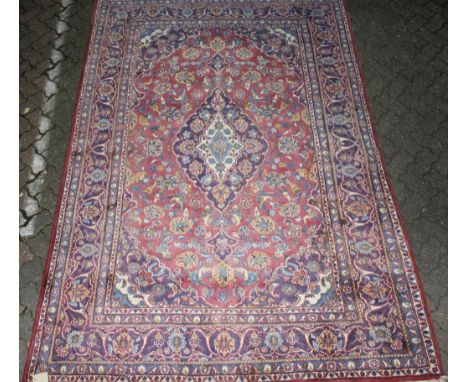 A Kashan carpet, pale pink ground with stylized floral decoration. 9ft 7ins x 6ft 4ins.