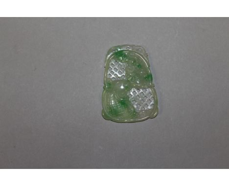 A CARVED AND PIERCED CELADON JADE PENDANT.