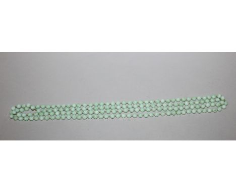 A GOOD QUALITY CHINESE JADE-LIKE APPLE-GREEN NECKLACE, each spherical bead of mottled white and apple-green tone, each bead 0