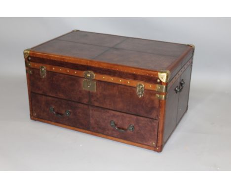 A GOOD LARGE LEATHER TRUNK with lifting lid over a long drawer, with cast iron carrying handles.3ft 0ins wide x 2ft 0ins deep