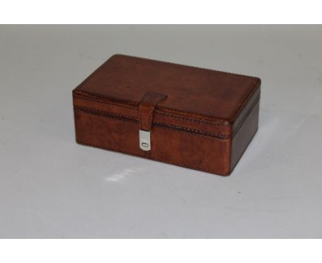 A LEATHER RECTANGULAR TRINKET BOX with magnetic clasp.8ins wide.
