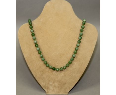 A GREEN JADE NECKLACE.