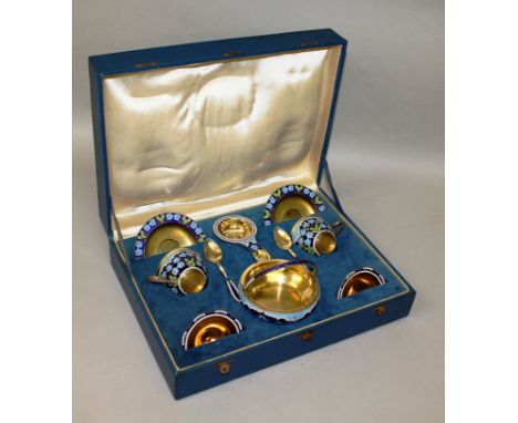 A GOOD RUSSIAN SILVER GILT AND ENAMEL TEA SET FOR TWO comprising two cups and saucers, two teaspoons, tea strainer and bowl w