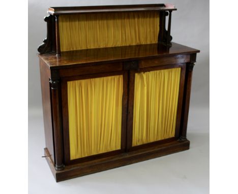 A REGENCY ROSEWOOD CHIFFONIER with shelf over two small drawers, double doors below with yellow silk panels, column supports 