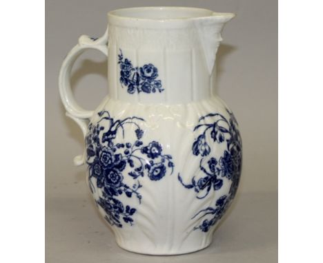 A WORCESTER BLUE AND WHITE CABBAGE LEAF JUG in relief with blue and white flowers.  7.75ins high.