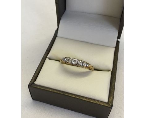 18ct gold ring set with 5 diamonds size R, approx 3.8g total weight. Total diamond carat weight approx .20ct.