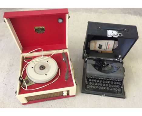 A vintage "Dansette" Junior record player together with an imperial typewriter.