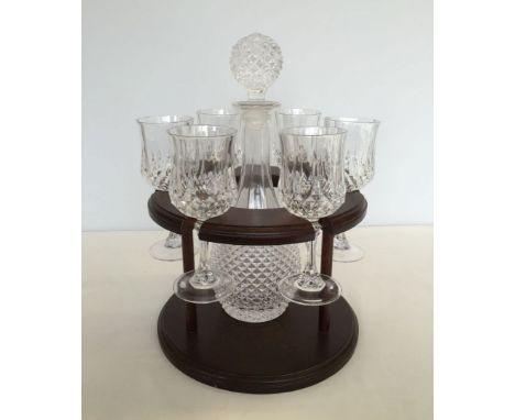 A glass decanter and 6 glasses in a display unit.