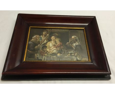 A vintage framed & glazed print of a family playing music around a table, 17cm x 26cm.