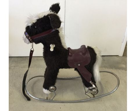 Donkey rocking horse on metal stand with converter wheels.