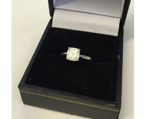 An 18ct white gold ring set with a princess cut solitaire mossanite (approx 1ct). Size K½.