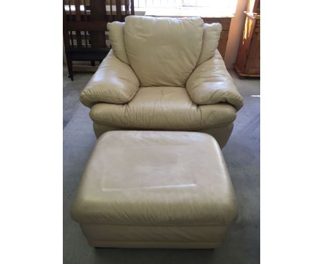 Cream leather armchair & stool.