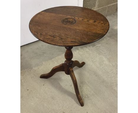 Arts & Crafts tripod oak wine table with carved rose roundel to centre. Carved 'RA' initials to underside. Approx 41cm diamet