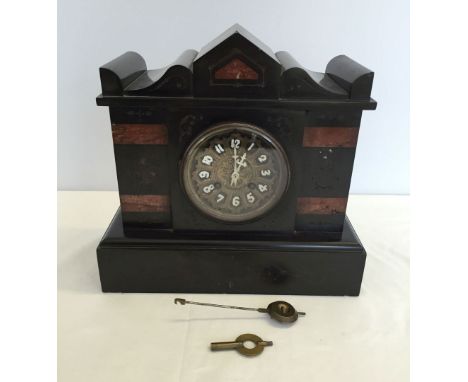 A vintage black slate mantle clock with red/brown marble sections.