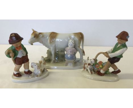3 continental porcelain figures - 2 Hummel style boys and a cow & milkmaid.