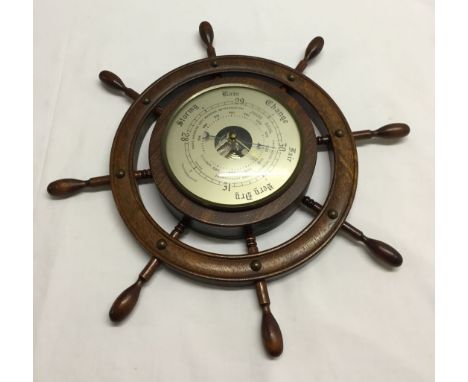 A ships wheel barometer.