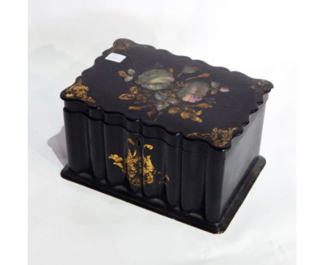 A Victorian papier mache tea caddy of rectangular wavy form, gilt painted decoration and inlaid mother-of-pearl floral design