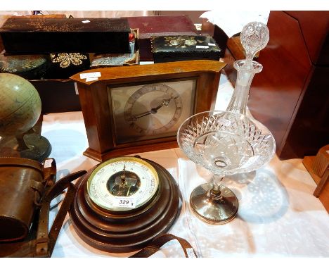 A pair of binoculars in a leather case, an aneroid barometer, an oak cased wall clock by Elliott, a stem glass bowl and a tal