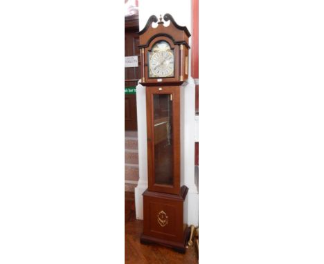 An reproduction longcase clock with swan neck pediment, silver dial, three day striking movement, with glass trunk door on a 